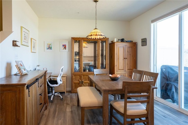 dining space with wood finished floors