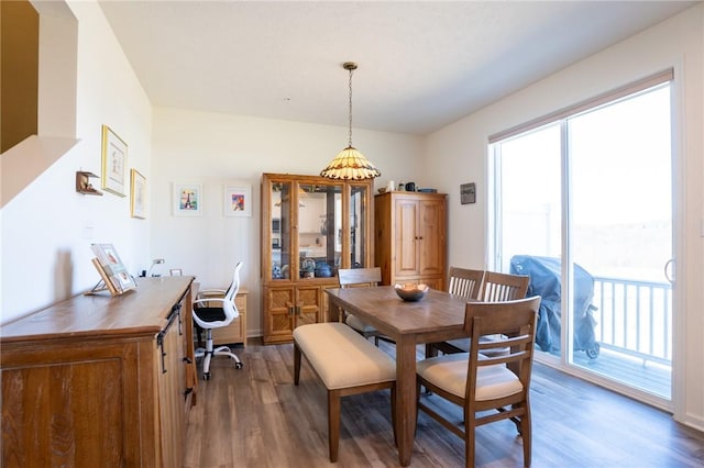 dining space with wood finished floors