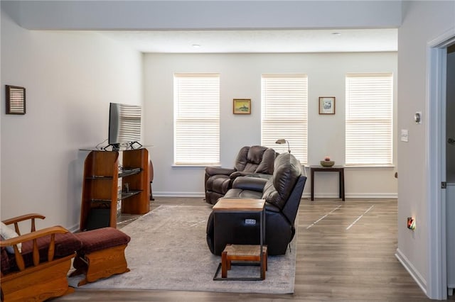 living area with wood finished floors and baseboards