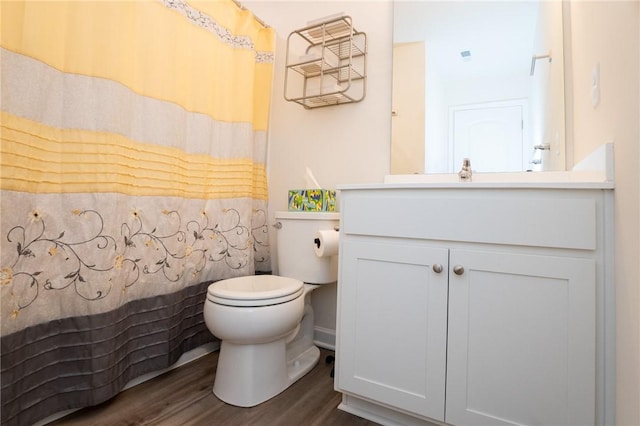 full bathroom with toilet, a shower with curtain, wood finished floors, and vanity