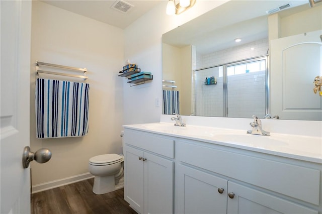 full bath featuring a stall shower, a sink, and visible vents