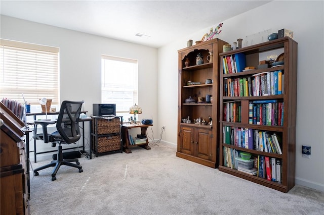 office featuring carpet, visible vents, and baseboards