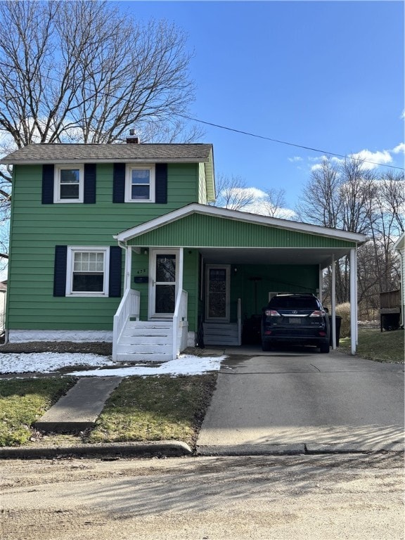 view of front of property with driveway and a carport