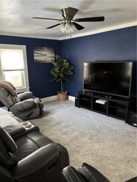 living room featuring ornamental molding, carpet flooring, baseboards, and a ceiling fan