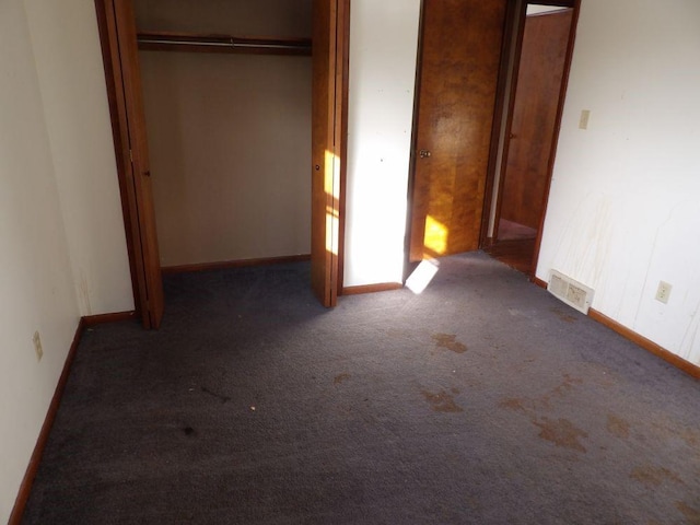 unfurnished bedroom with baseboards, visible vents, a closet, and carpet flooring