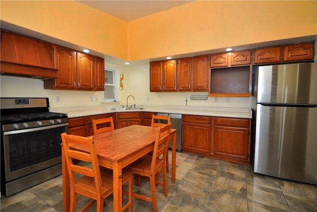 kitchen with stainless steel appliances, a sink, light countertops, brown cabinetry, and custom range hood