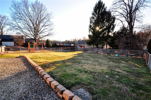 view of yard with a playground and a fenced backyard