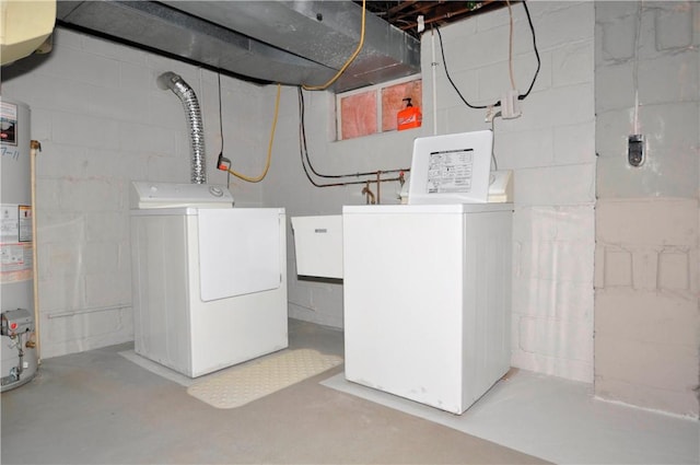 washroom with laundry area, washer and clothes dryer, and gas water heater