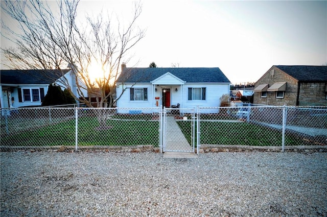 bungalow-style home with a front lawn, a fenced front yard, a chimney, and a gate