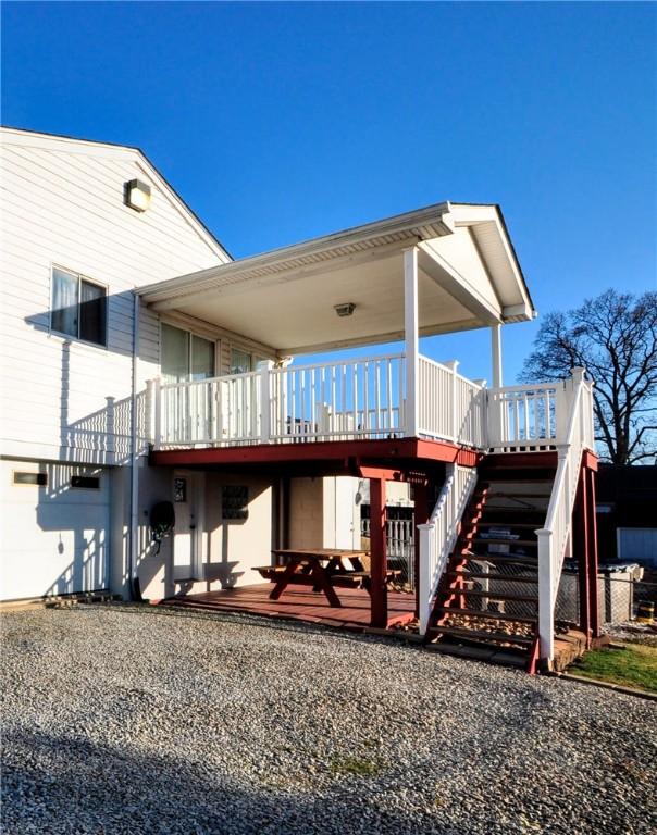 rear view of house featuring stairs