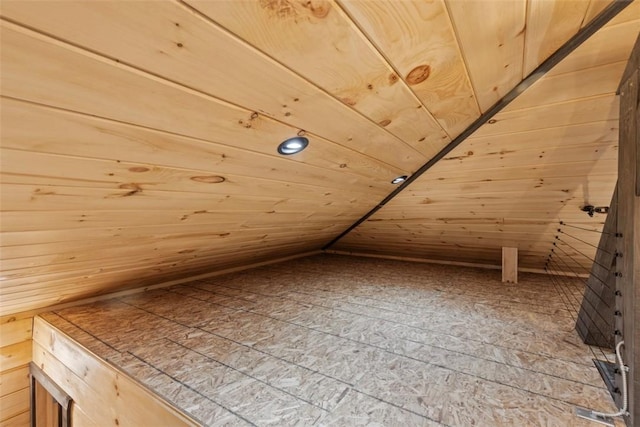 additional living space with wood walls, wood ceiling, and lofted ceiling