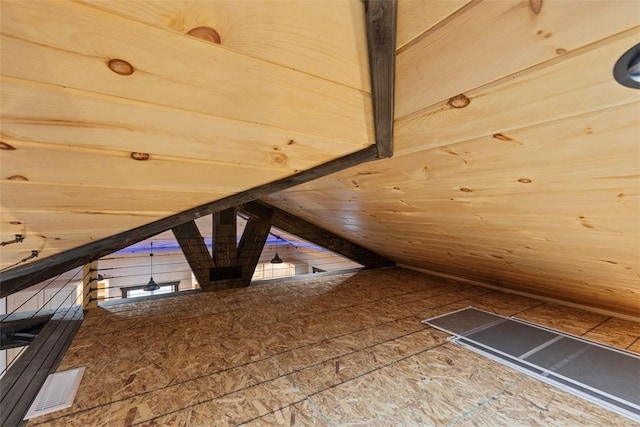 bonus room featuring wooden walls and lofted ceiling