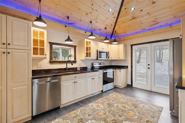 kitchen featuring a sink, stainless steel appliances, and dark countertops