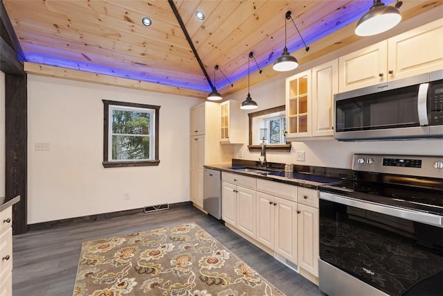 kitchen with dark countertops, visible vents, wood ceiling, appliances with stainless steel finishes, and a sink