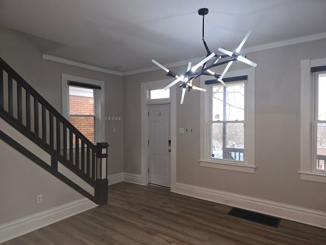 entryway with dark wood-style flooring, visible vents, baseboards, stairs, and ornamental molding