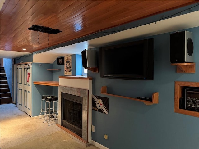 living room featuring stairs, wooden ceiling, a fireplace, and baseboards