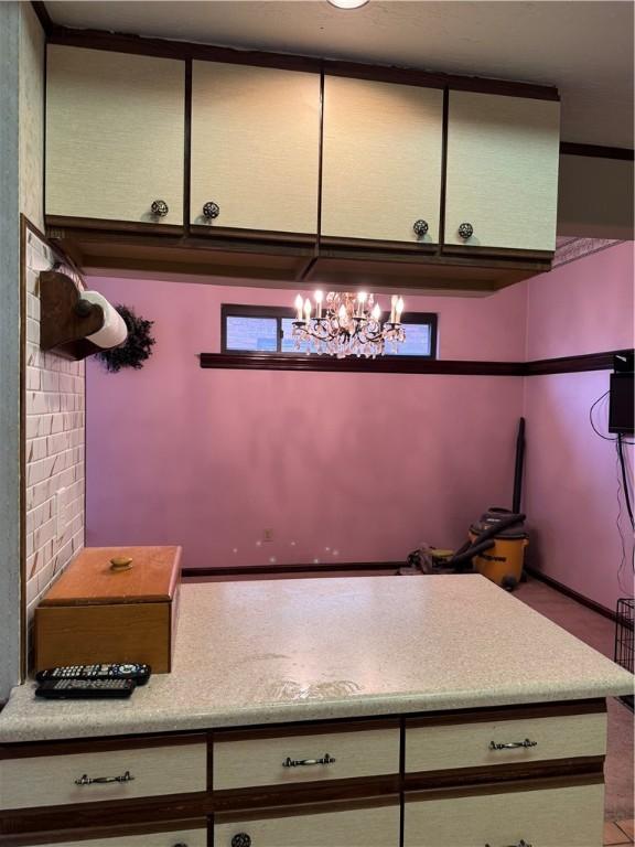 kitchen featuring a chandelier and light countertops