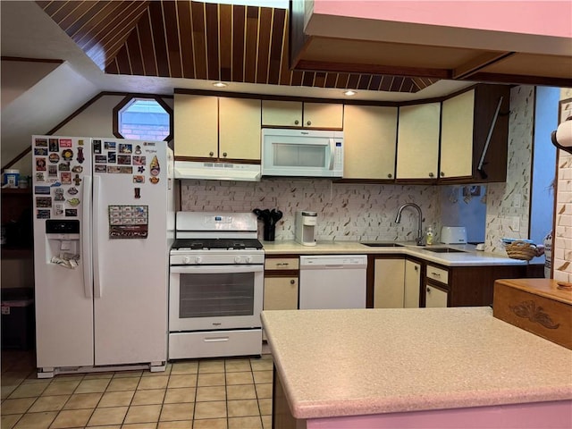 kitchen featuring white appliances, tasteful backsplash, light tile patterned floors, light countertops, and under cabinet range hood