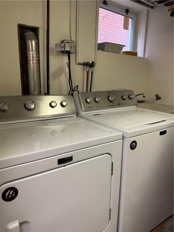 washroom featuring laundry area and washer and clothes dryer