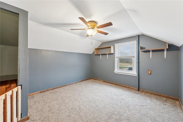 bonus room with carpet floors, vaulted ceiling, baseboards, and a ceiling fan