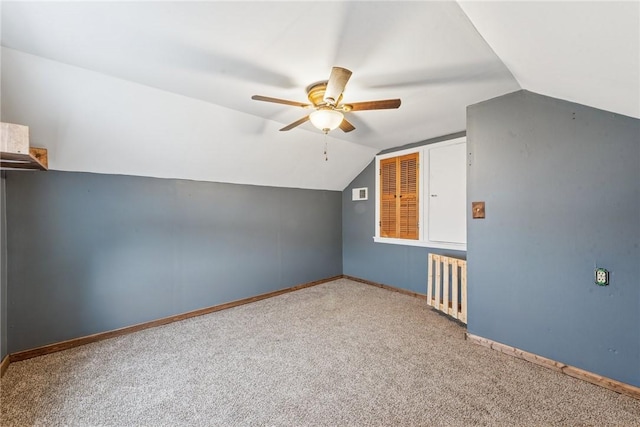 bonus room featuring lofted ceiling, a ceiling fan, baseboards, and carpet flooring