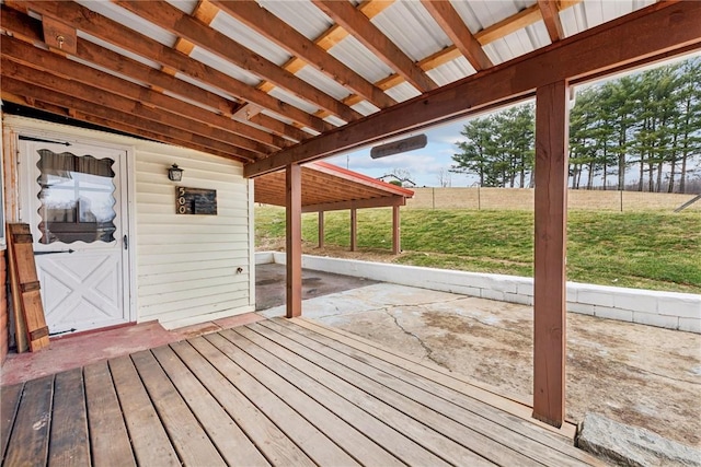 wooden terrace featuring a patio area and a yard