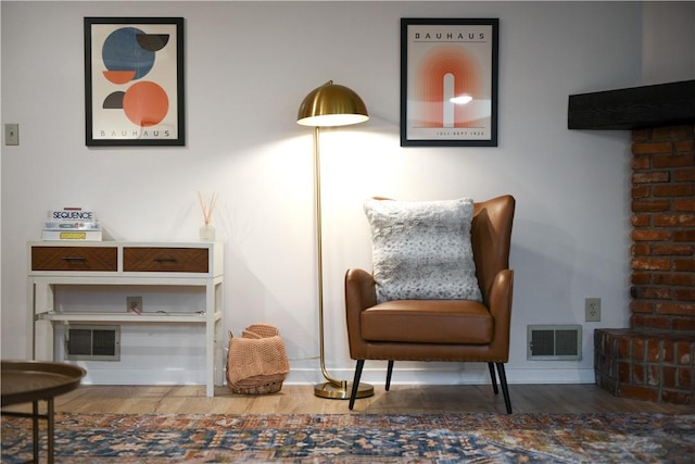 living area featuring wood finished floors and visible vents