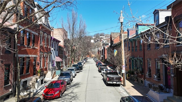 view of street featuring sidewalks, curbs, and street lights