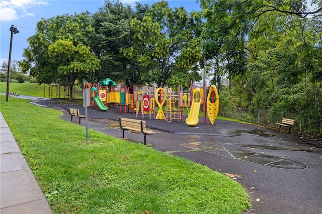 community play area with a yard and fence