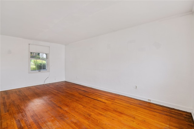 empty room with baseboards and wood finished floors