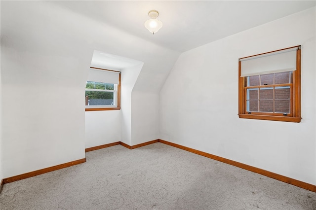 bonus room featuring carpet, baseboards, and vaulted ceiling