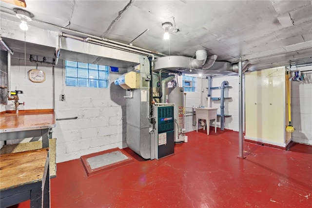 below grade area featuring a sink, gas water heater, and concrete block wall