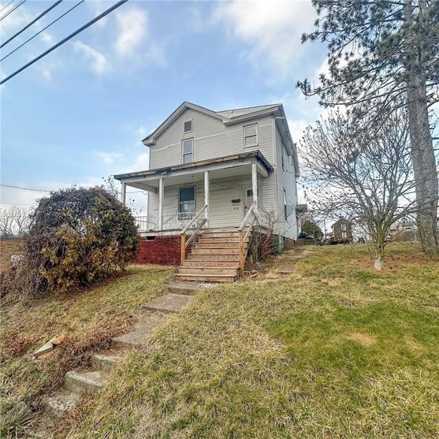 view of front facade with covered porch and a front lawn