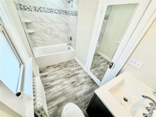5620 Stanton Ave, East Liberty, PA 15206 - full bathroom with toilet, wood tiled floor, shower / washtub combination, and vanity