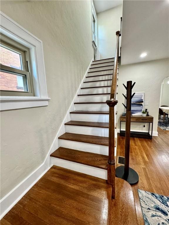 5620 Stanton Ave, East Liberty, PA 15206 - stairs with baseboards, wood finished floors, and a textured wall