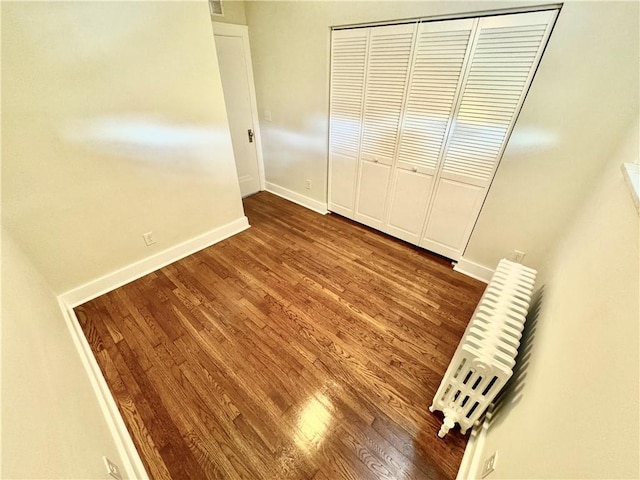 5620 Stanton Ave, East Liberty, PA 15206 - unfurnished bedroom featuring a closet, baseboards, and wood finished floors