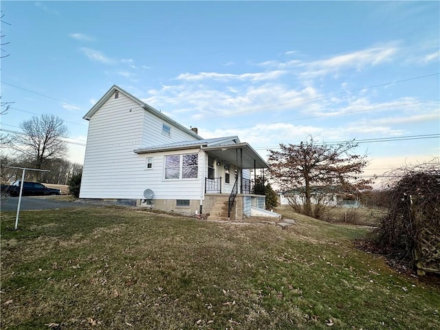 rear view of property featuring a lawn