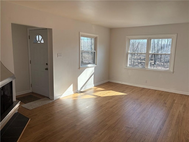 entryway with baseboards and wood finished floors