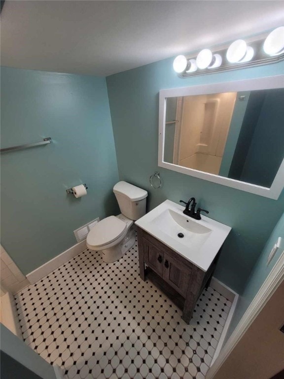 bathroom featuring tile patterned flooring, toilet, visible vents, vanity, and baseboards