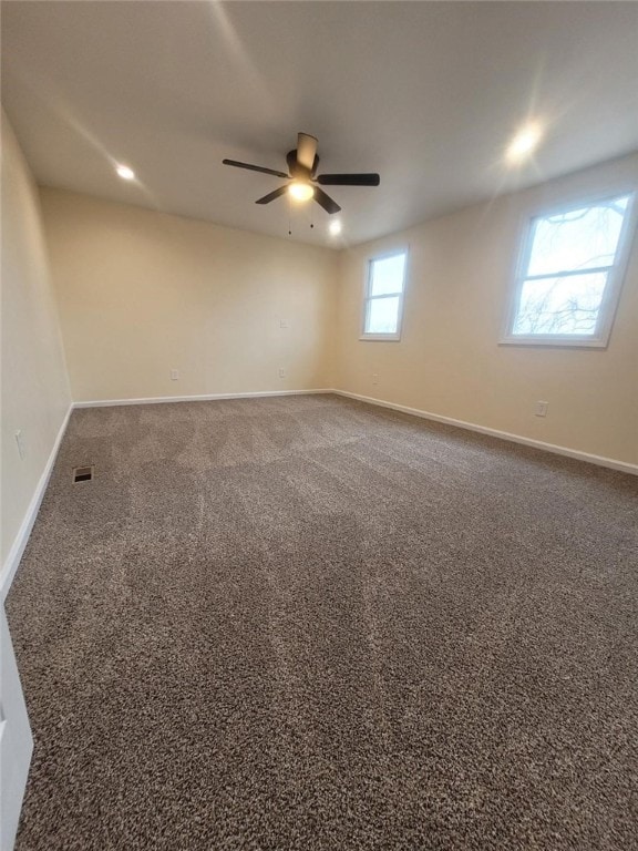 unfurnished room featuring ceiling fan, carpet, and baseboards