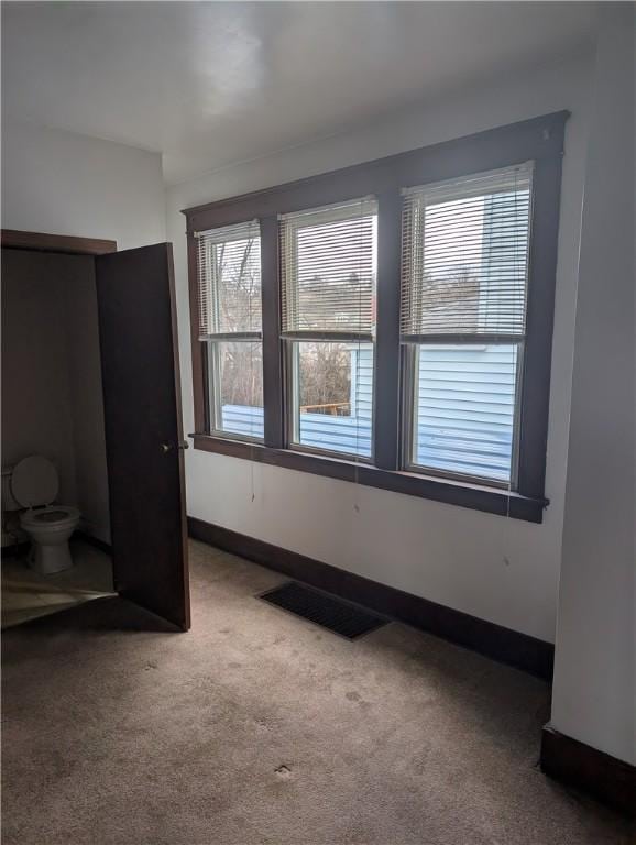 unfurnished bedroom featuring visible vents, baseboards, and carpet floors