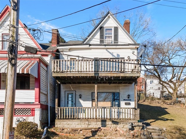 view of front of property with a porch and a chimney