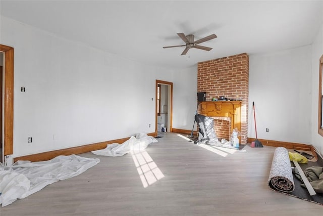 living room with ceiling fan, wood finished floors, and baseboards