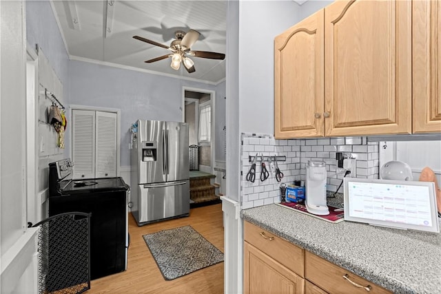 kitchen featuring electric range oven, ornamental molding, stainless steel fridge, and light brown cabinets