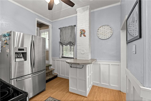 kitchen with crown molding, light wood-style floors, and stainless steel fridge with ice dispenser