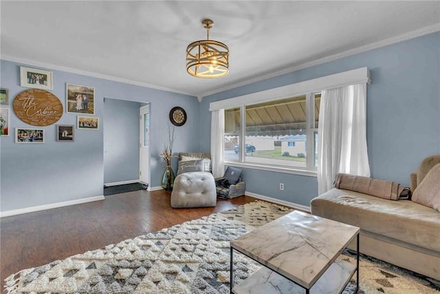 living area with crown molding, wood finished floors, and baseboards