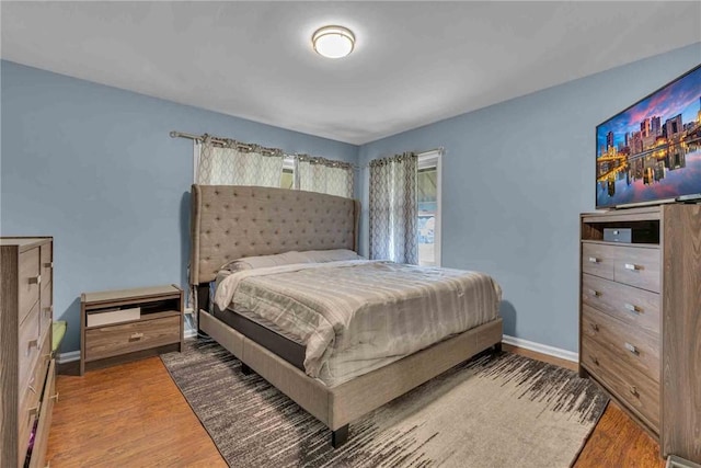 bedroom featuring baseboards and wood finished floors