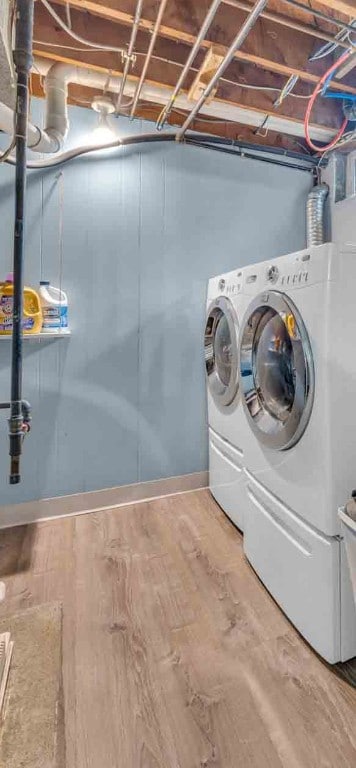 laundry area featuring laundry area, light wood finished floors, and washer and dryer