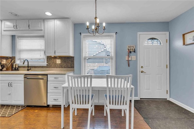 kitchen with a wealth of natural light, white cabinets, and dishwasher