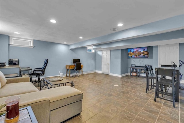 living area with recessed lighting, visible vents, and baseboards